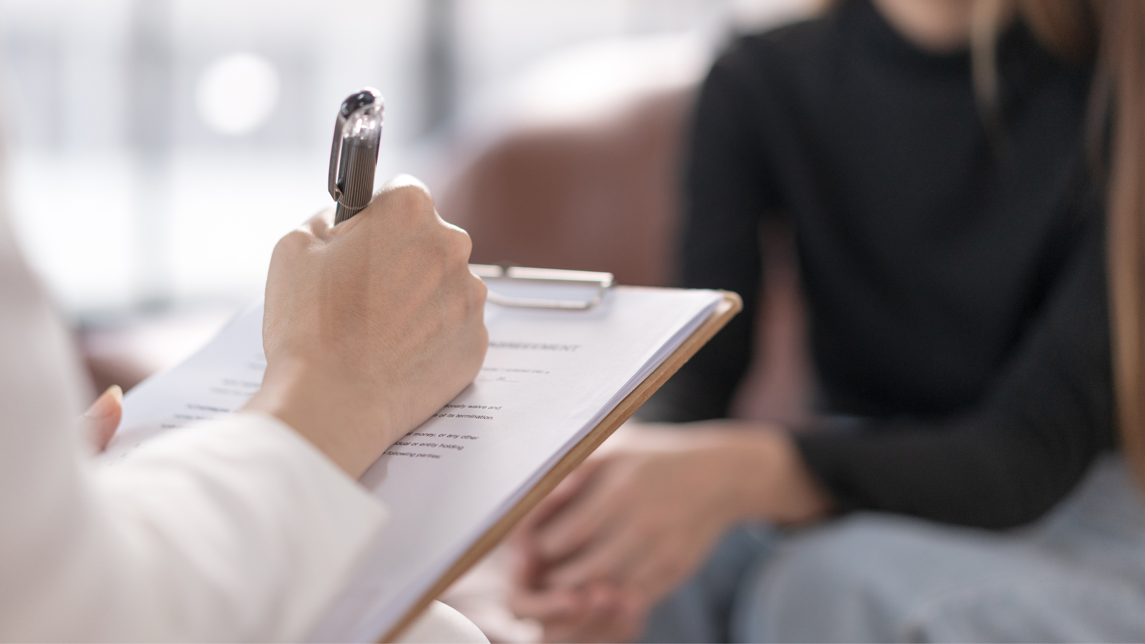 Care provider sitting down with patient