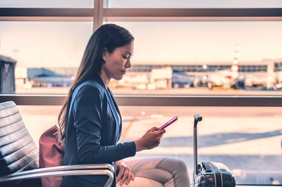 Businesswoman on phone at airport