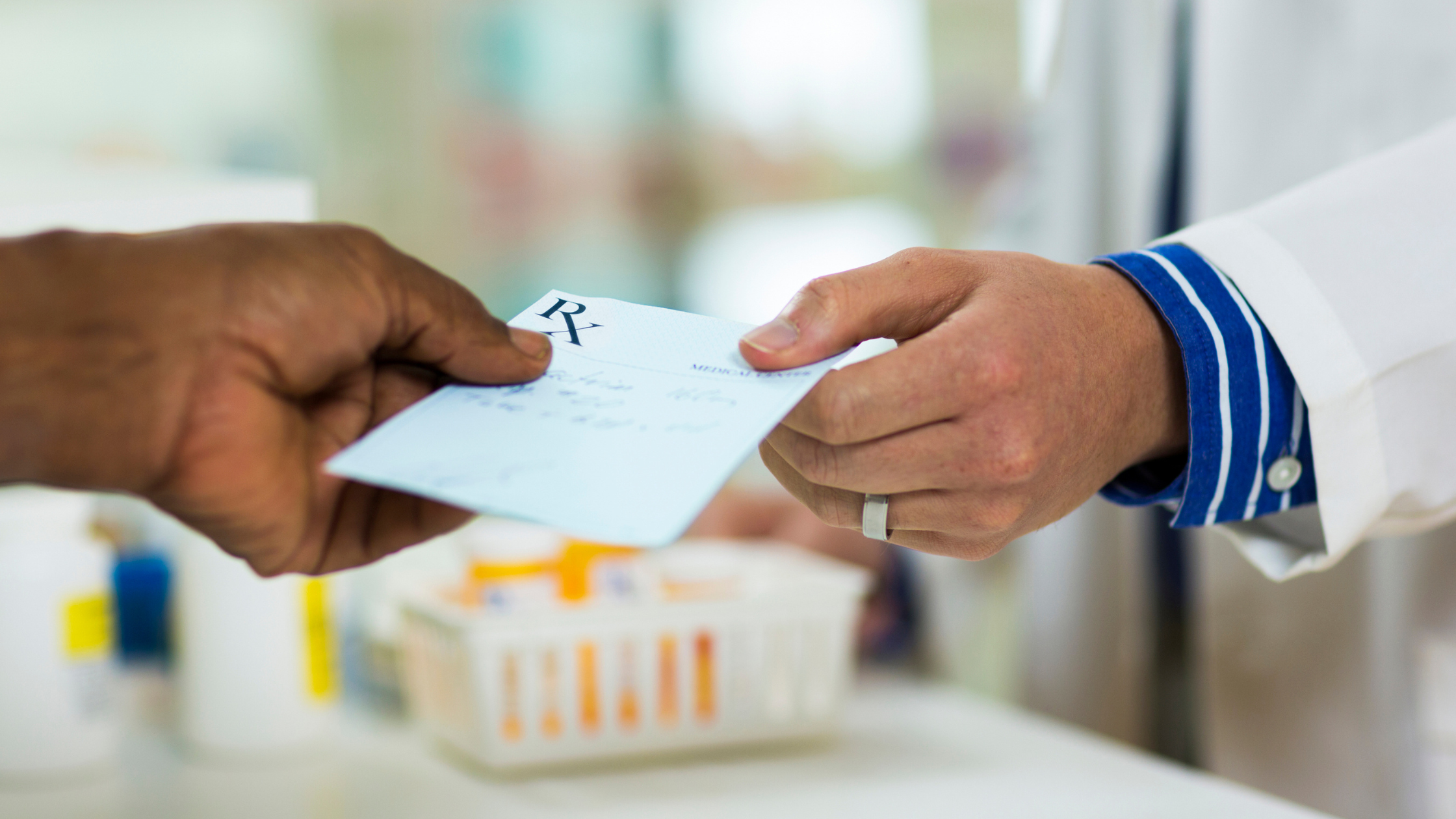 Doctor handing someone a prescription paper