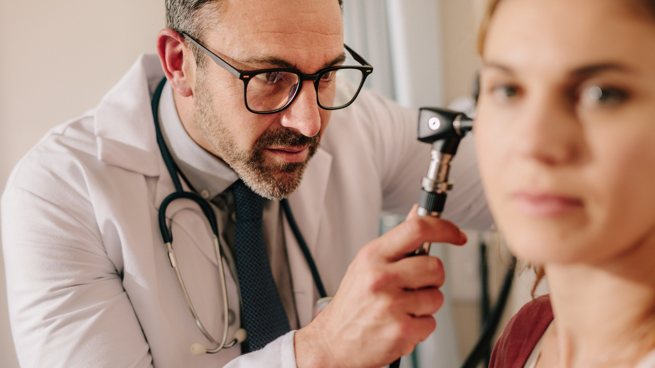 Doctor examining a patient's ear