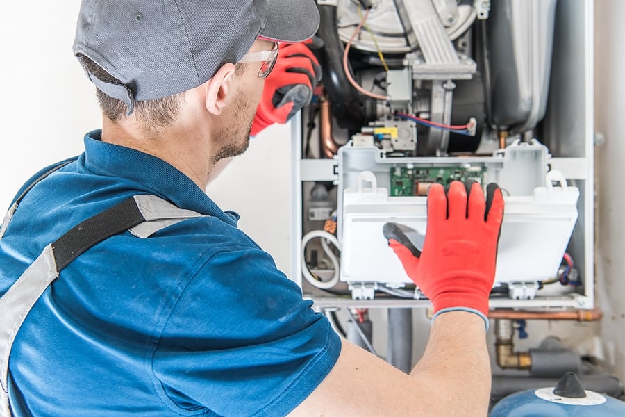 Technician fixing furnace