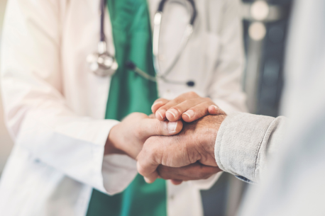 Doctor holding patient's hand