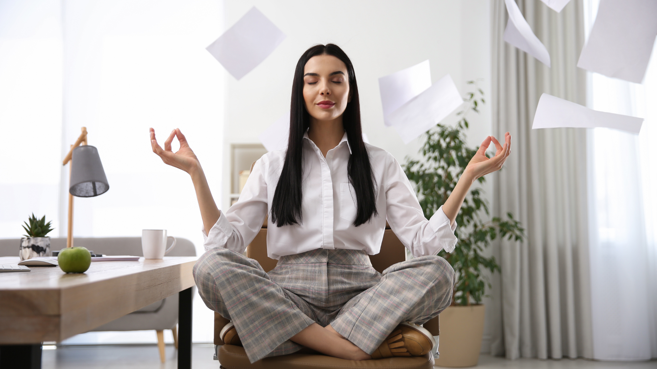 female employee meditating at work