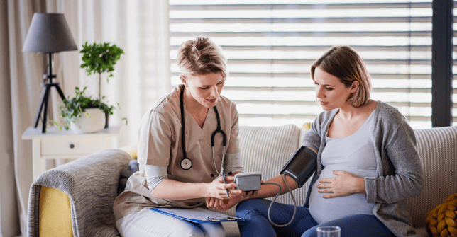 Midwife on a couch with a patient