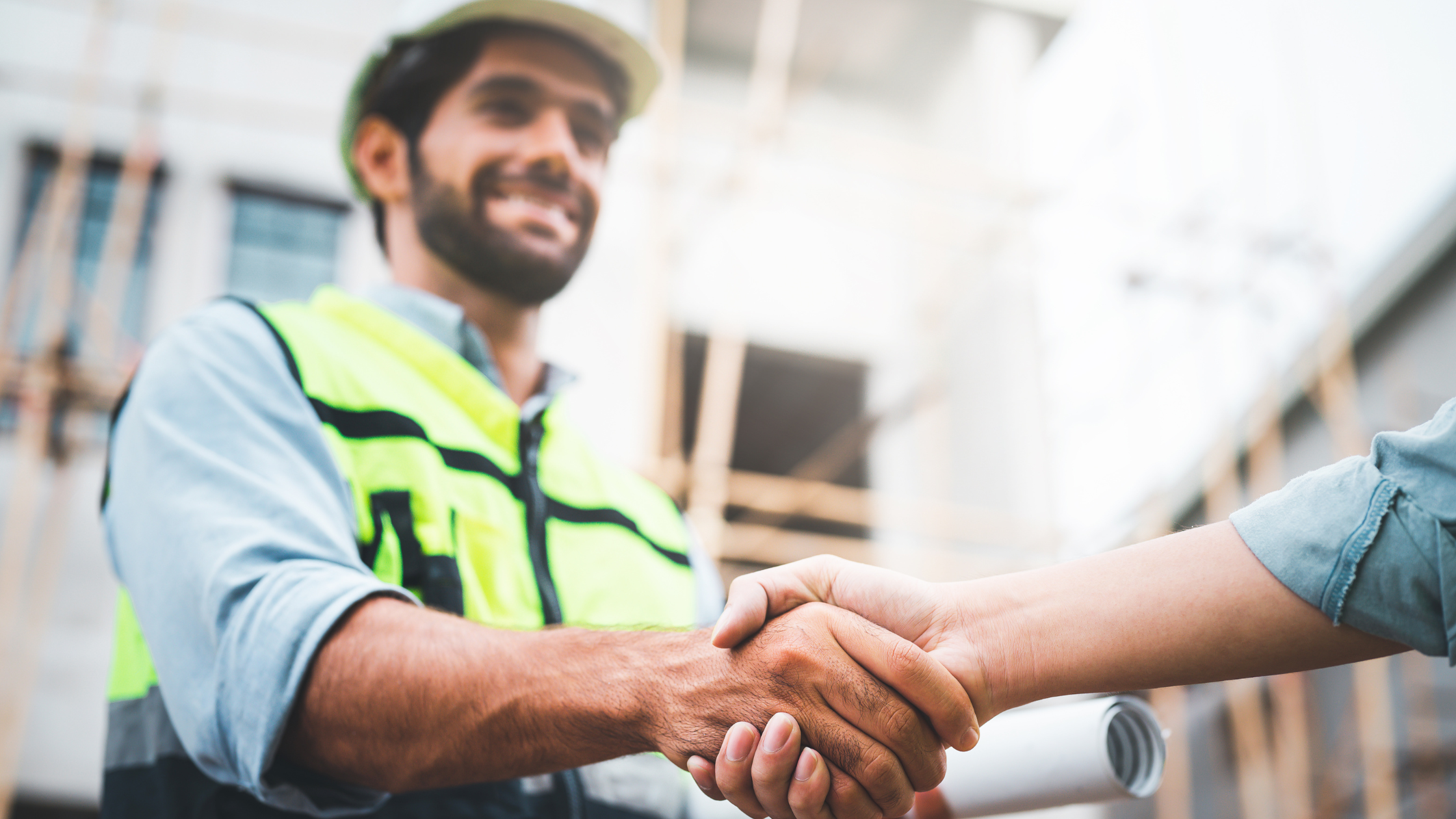 Construction worker shaking hands with someone