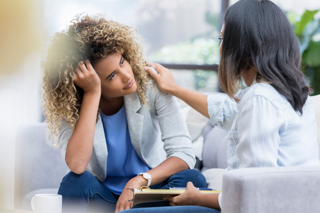 woman consoling another woman